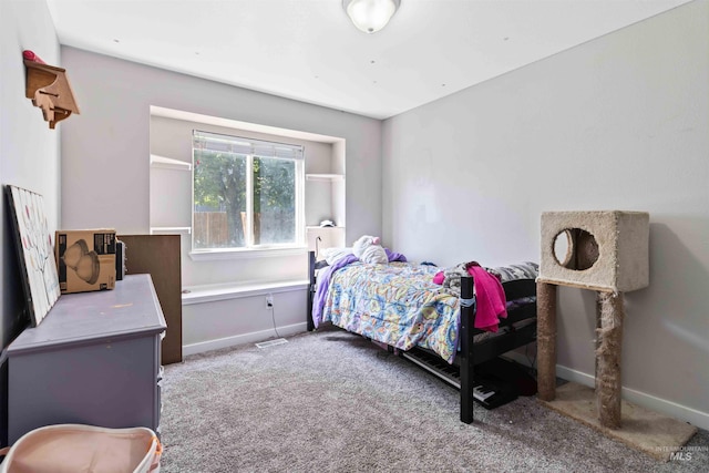 bedroom featuring carpet and baseboards