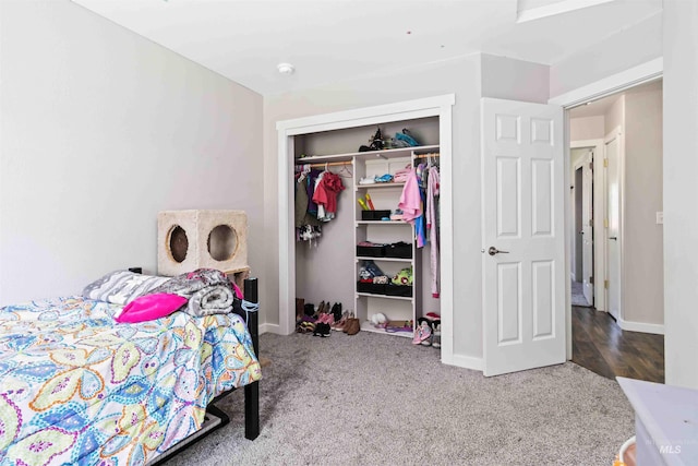 bedroom with a closet, carpet, and baseboards