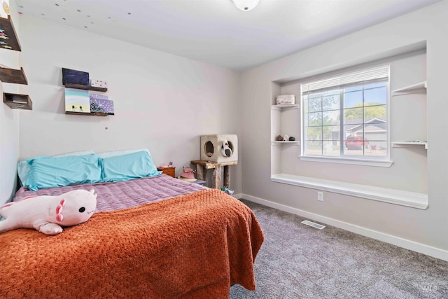 carpeted bedroom featuring baseboards