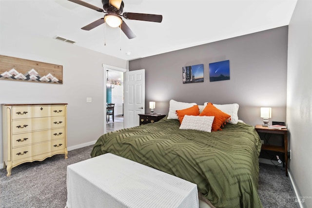 carpeted bedroom featuring baseboards and a ceiling fan