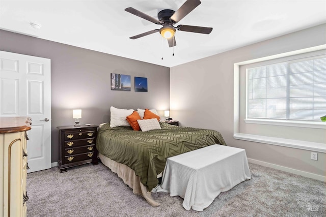 bedroom featuring light carpet, baseboards, and ceiling fan