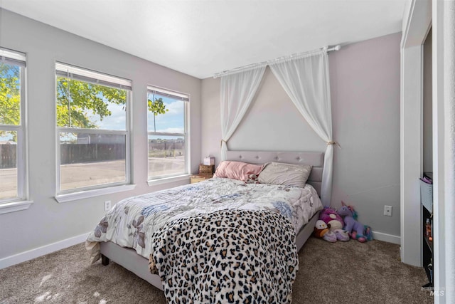 bedroom featuring carpet floors and baseboards
