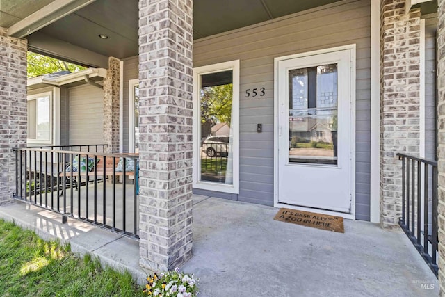 view of exterior entry featuring a porch