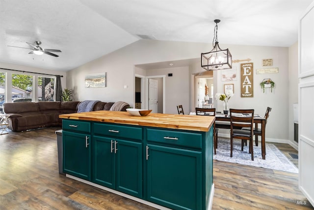kitchen featuring wood counters, green cabinetry, vaulted ceiling, dark wood finished floors, and a chandelier