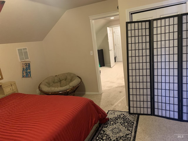 bedroom with lofted ceiling and carpet floors