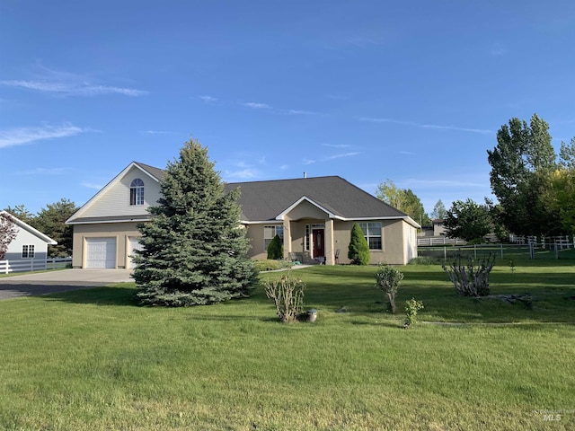 view of front of home featuring a garage and a front yard