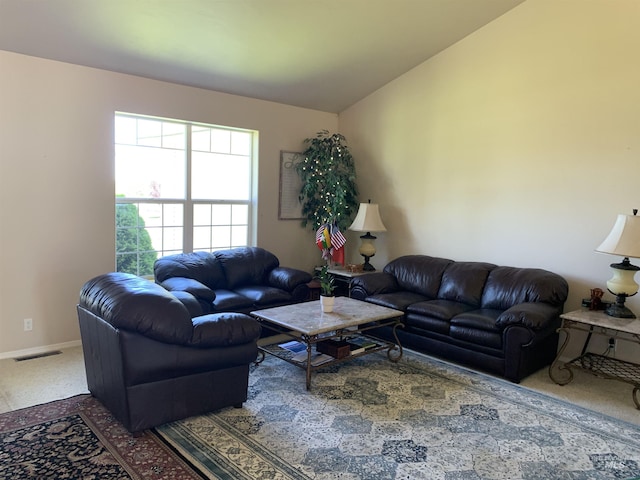 carpeted living room with vaulted ceiling