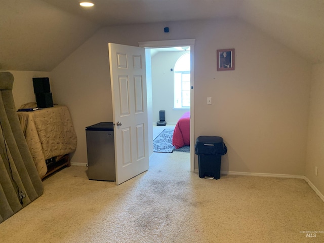 bonus room featuring lofted ceiling and light carpet