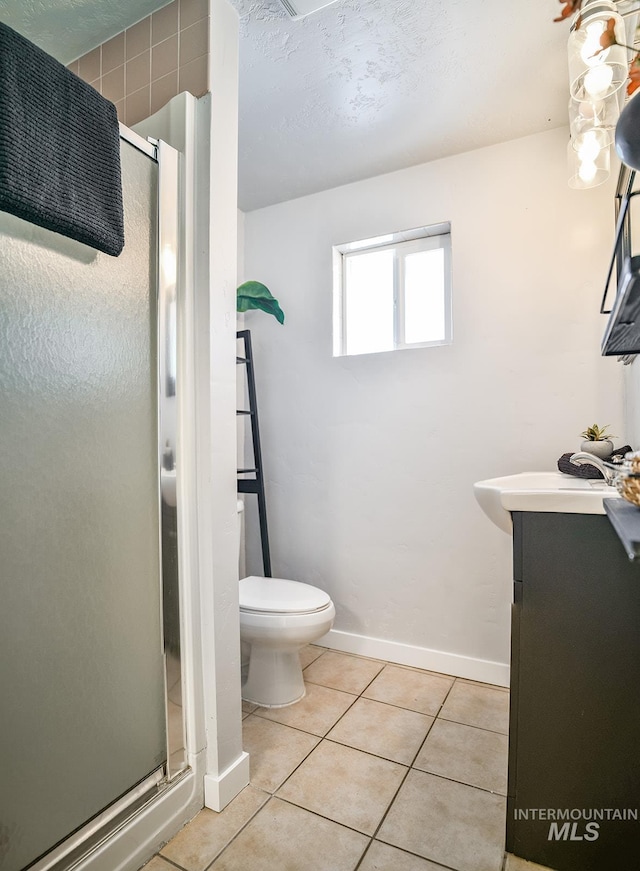 bathroom with vanity, an enclosed shower, tile patterned floors, and toilet