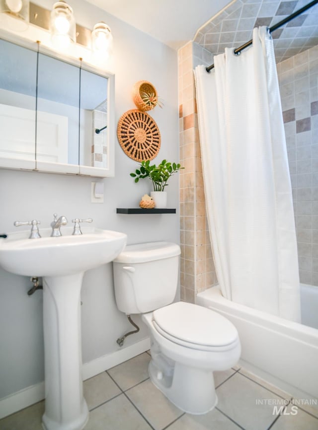 bathroom with tile patterned flooring, toilet, and shower / bath combo with shower curtain