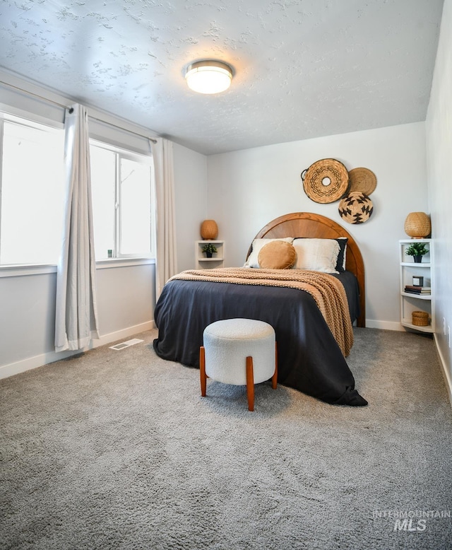 bedroom with carpet flooring and a textured ceiling