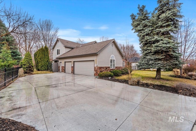 view of property exterior with fence, a garage, driveway, and roof with shingles