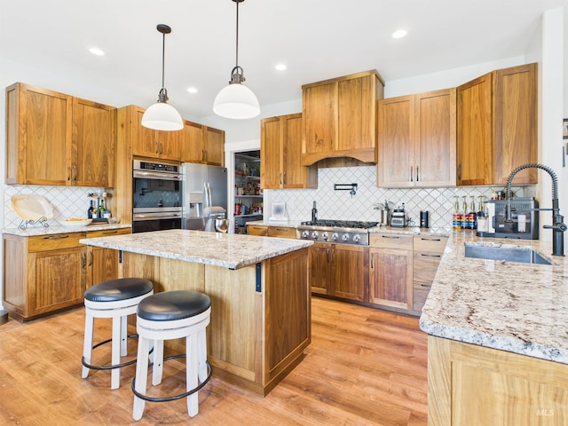 515 School St, Albion, ID 83311 - kitchen with appliances with stainless steel finishes, a center island, tasteful backsplash, light stone counters, and recessed lighting