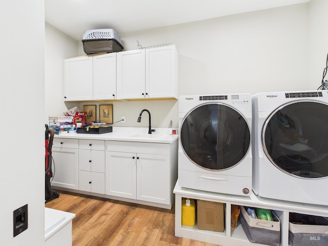 515 School St, Albion, ID 83311 - laundry room with cabinet space, washer and clothes dryer, and light wood-style flooring