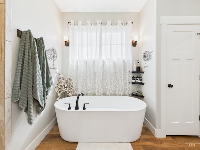 515 School St, Albion, ID 83311 - bathroom with a soaking tub and wood finished floors