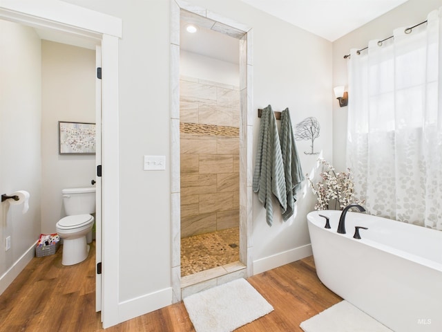 515 School St, Albion, ID 83311 - full bathroom with wood finished floors, a walk in shower, and a freestanding bath