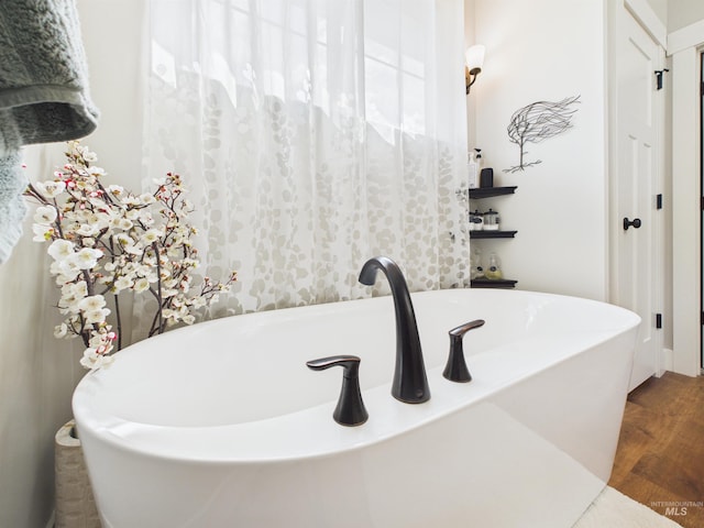 515 School St, Albion, ID 83311 - full bathroom featuring a soaking tub and wood finished floors