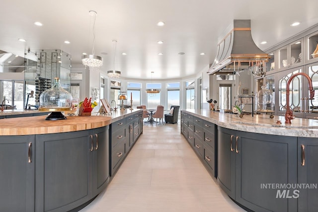 kitchen featuring plenty of natural light, decorative light fixtures, and a large island