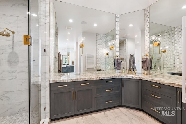 bathroom with tile flooring, double vanity, and a shower with door