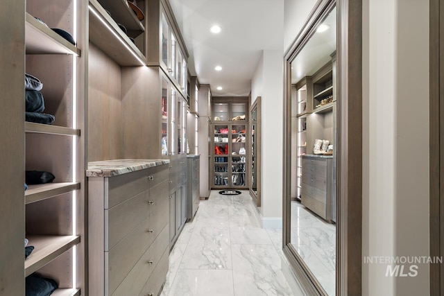 spacious closet with light tile floors