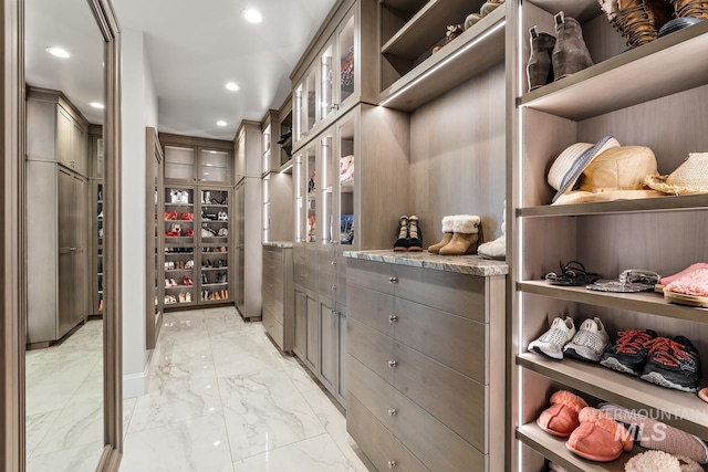 walk in closet featuring light tile floors