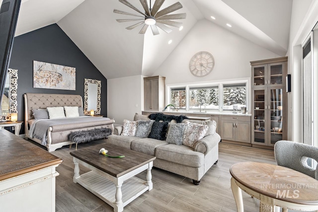 interior space featuring high vaulted ceiling, ceiling fan, and light wood-type flooring