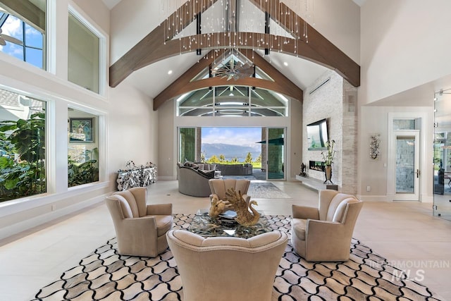 living room with a mountain view, a chandelier, a towering ceiling, and tile floors