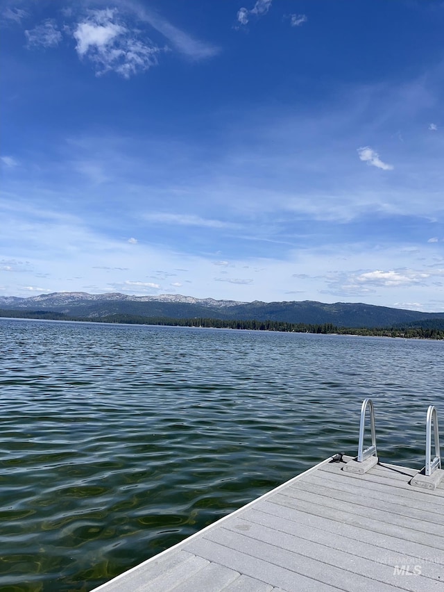 view of dock featuring a water and mountain view