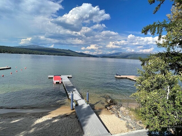 water view featuring a mountain view and a boat dock