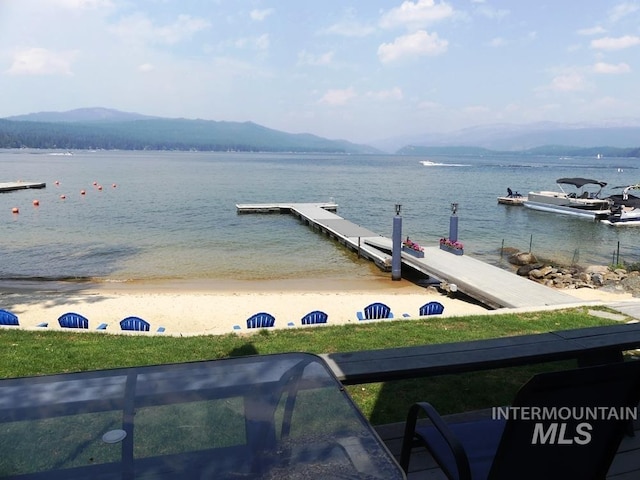 property view of water with a boat dock and a mountain view