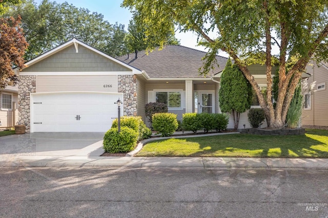 view of front of property with a front lawn and a garage