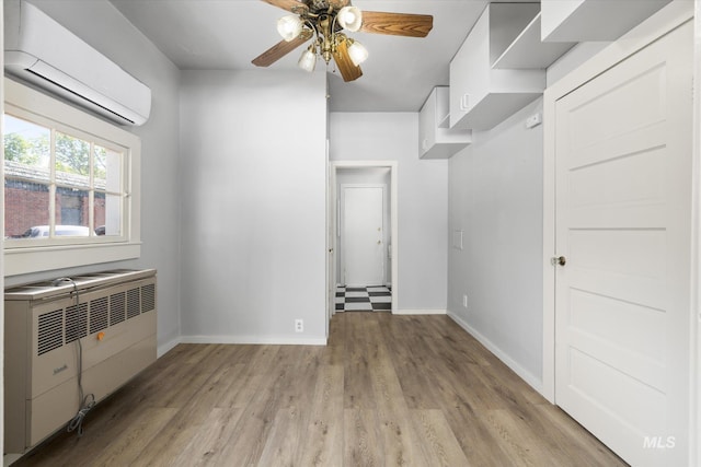 710 N 15th St, Boise, ID 83702 - unfurnished room with a wall mounted air conditioner, ceiling fan, light wood finished floors, and radiator