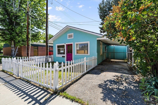 710 N 15th St, Boise, ID 83702 - bungalow-style house featuring a fenced front yard, asphalt driveway, and stucco siding