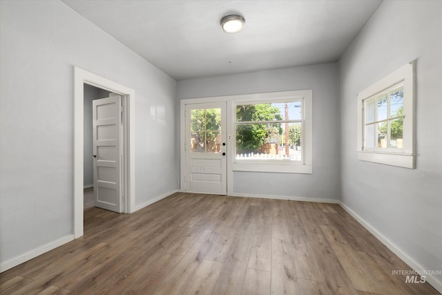 710 N 15th St, Boise, ID 83702 - empty room featuring plenty of natural light and wood finished floors