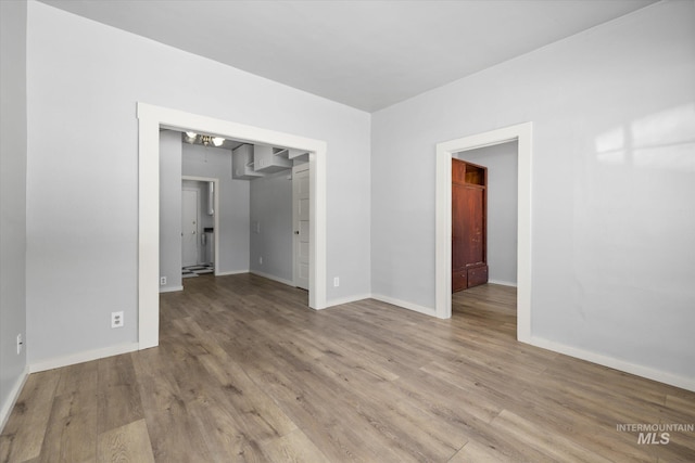 710 N 15th St, Boise, ID 83702 - spare room featuring wood finished floors and a chandelier