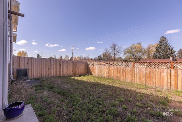 view of yard featuring cooling unit and a fenced backyard