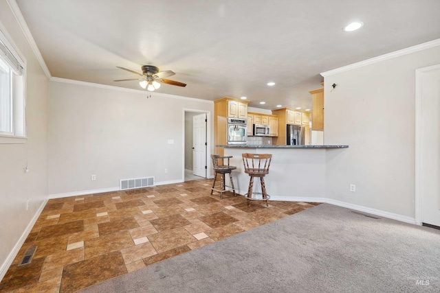 kitchen with appliances with stainless steel finishes, visible vents, and crown molding