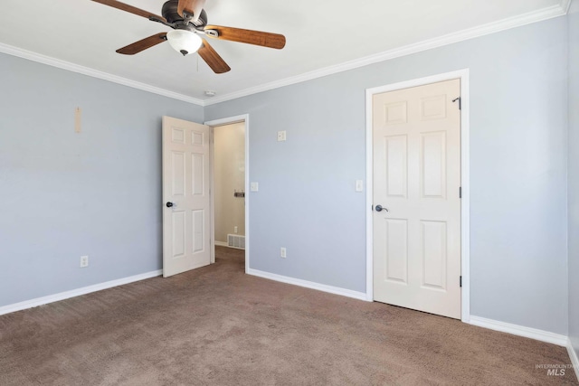 unfurnished bedroom with baseboards, visible vents, ornamental molding, and carpet flooring