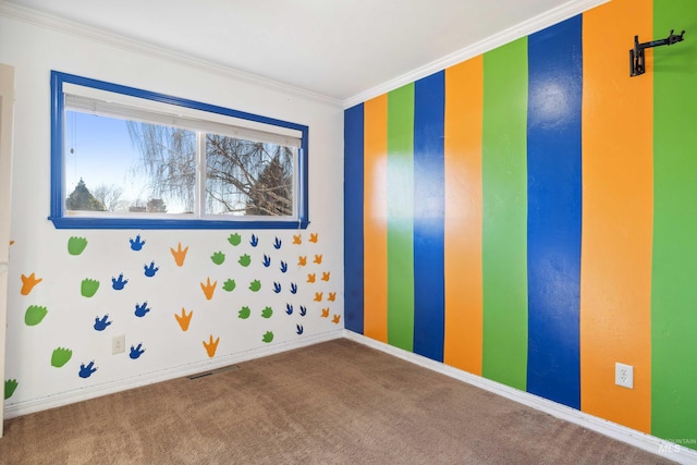 carpeted empty room featuring ornamental molding, visible vents, and baseboards