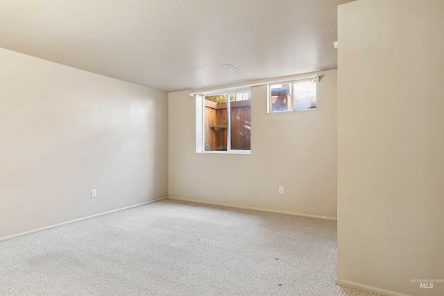 spare room with carpet floors and baseboards