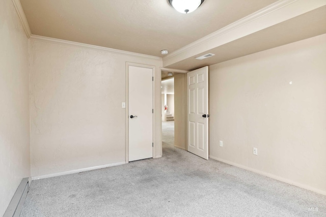 spare room with baseboards, ornamental molding, and carpet flooring