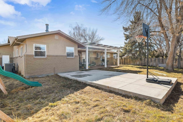 back of property featuring brick siding, a yard, a patio, fence, and a pergola