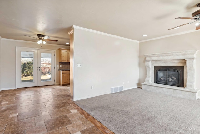 unfurnished living room with french doors, visible vents, crown molding, and baseboards