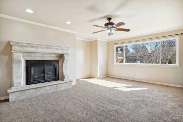 unfurnished living room with a fireplace, baseboards, crown molding, and carpet flooring