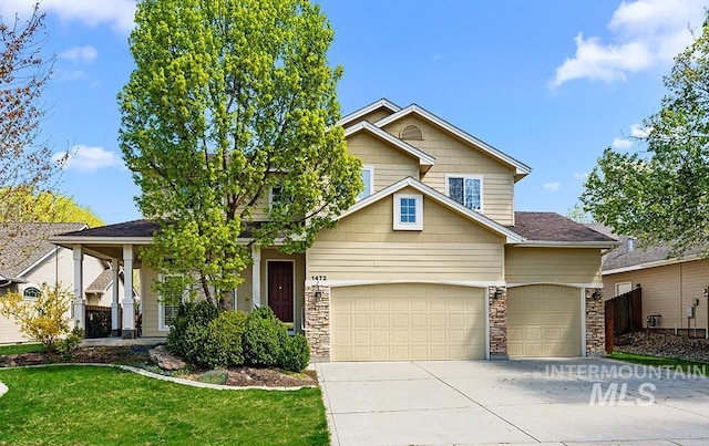 1472 N Watson Ave, Eagle, ID 83616 - view of front of property with an attached garage, concrete driveway, a front yard, and stone siding