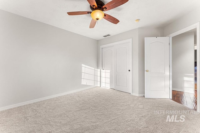 1472 N Watson Ave, Eagle, ID 83616 - unfurnished bedroom with carpet flooring, baseboards, a closet, a ceiling fan, and a textured ceiling