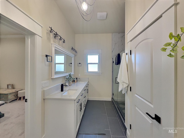 bathroom featuring a chandelier, vanity, tile patterned floors, and a shower with shower door