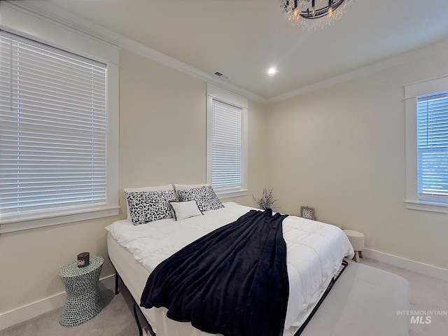 bedroom with crown molding and carpet floors