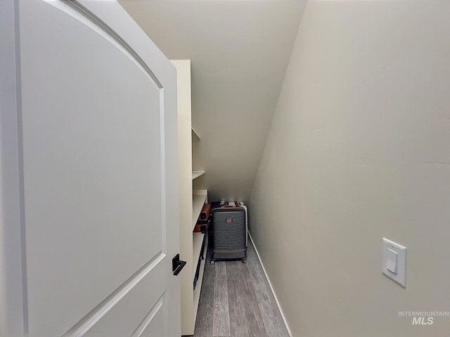 interior space with hardwood / wood-style floors and lofted ceiling