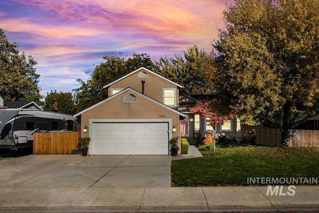 view of front of home featuring a garage and a lawn